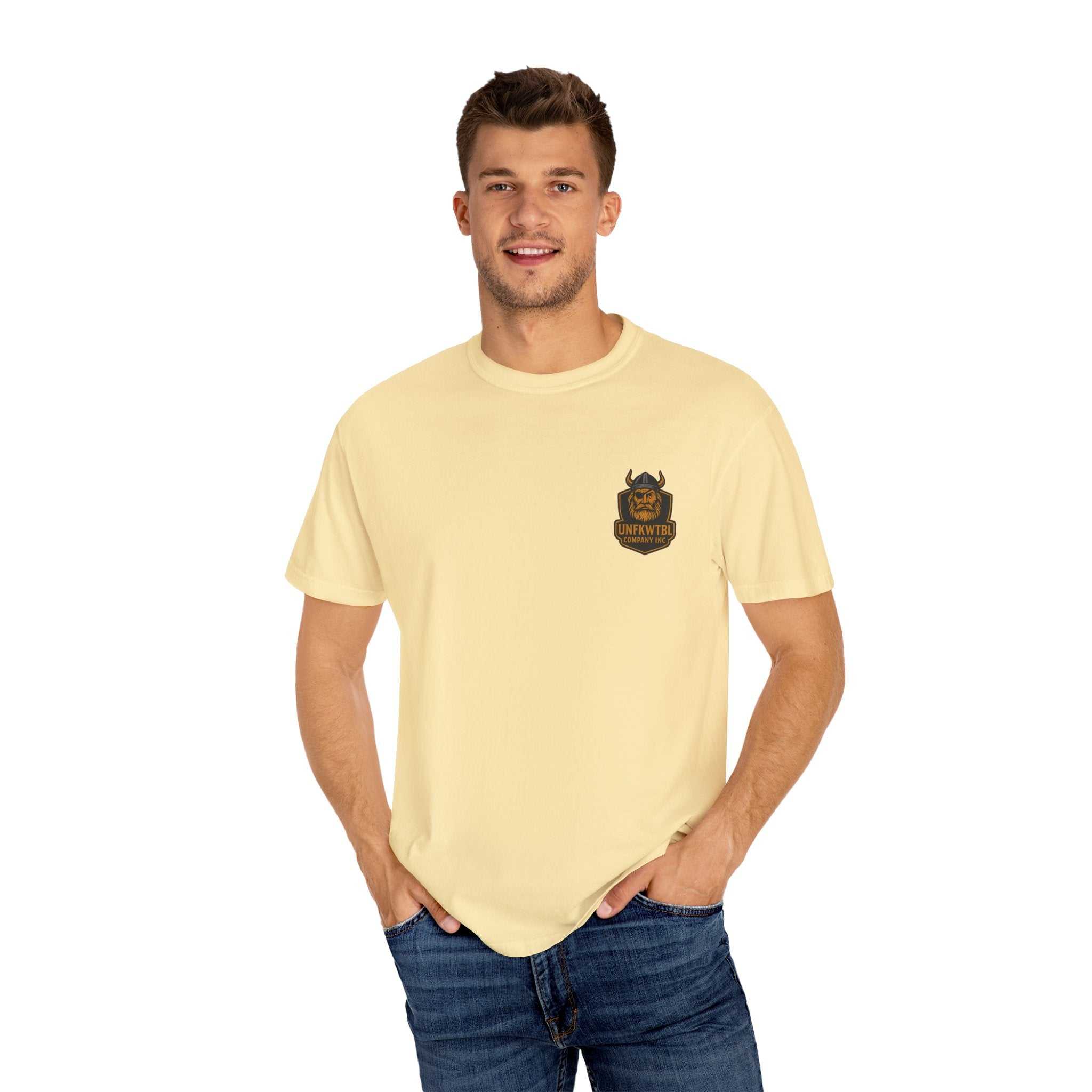 Unisex garment-dyed t-shirt in pale yellow with Beast King vintage graphic worn by smiling man in casual jeans