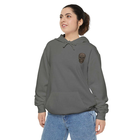 Unisex garment-dyed hoodie in gray with skull graphic, relaxed fit, cotton-polyester blend.