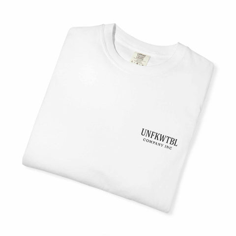 Folded white unisex T-shirt with small UNFKWTBL Company Inc logo on front, made of 100% US cotton, featuring Chucky cocktail design for horror fans.