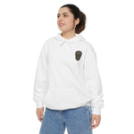 Unisex white garment-dyed hoodie with black skull graphic, relaxed fit, and front pocket, styled with blue jeans