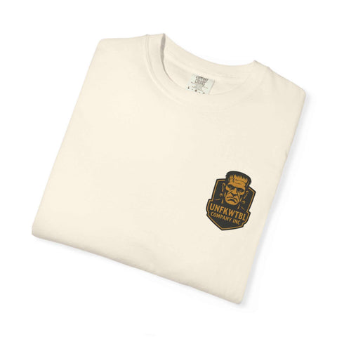 Folded cream-colored T-shirt with Bride of Frankenstein graphic and UNFKWTBL logo on front pocket area
