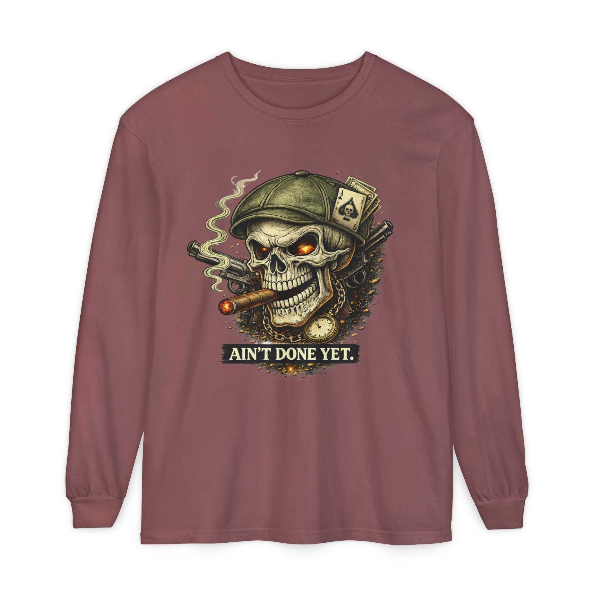 Ain't Done Yet Skull long sleeve tee with skull and cigar design on faded rose-mauve garment-dyed fabric