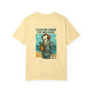 Unisex pale yellow t-shirt with graphic of Pennywise holding a pineapple on beach and text Floating Under The Influence