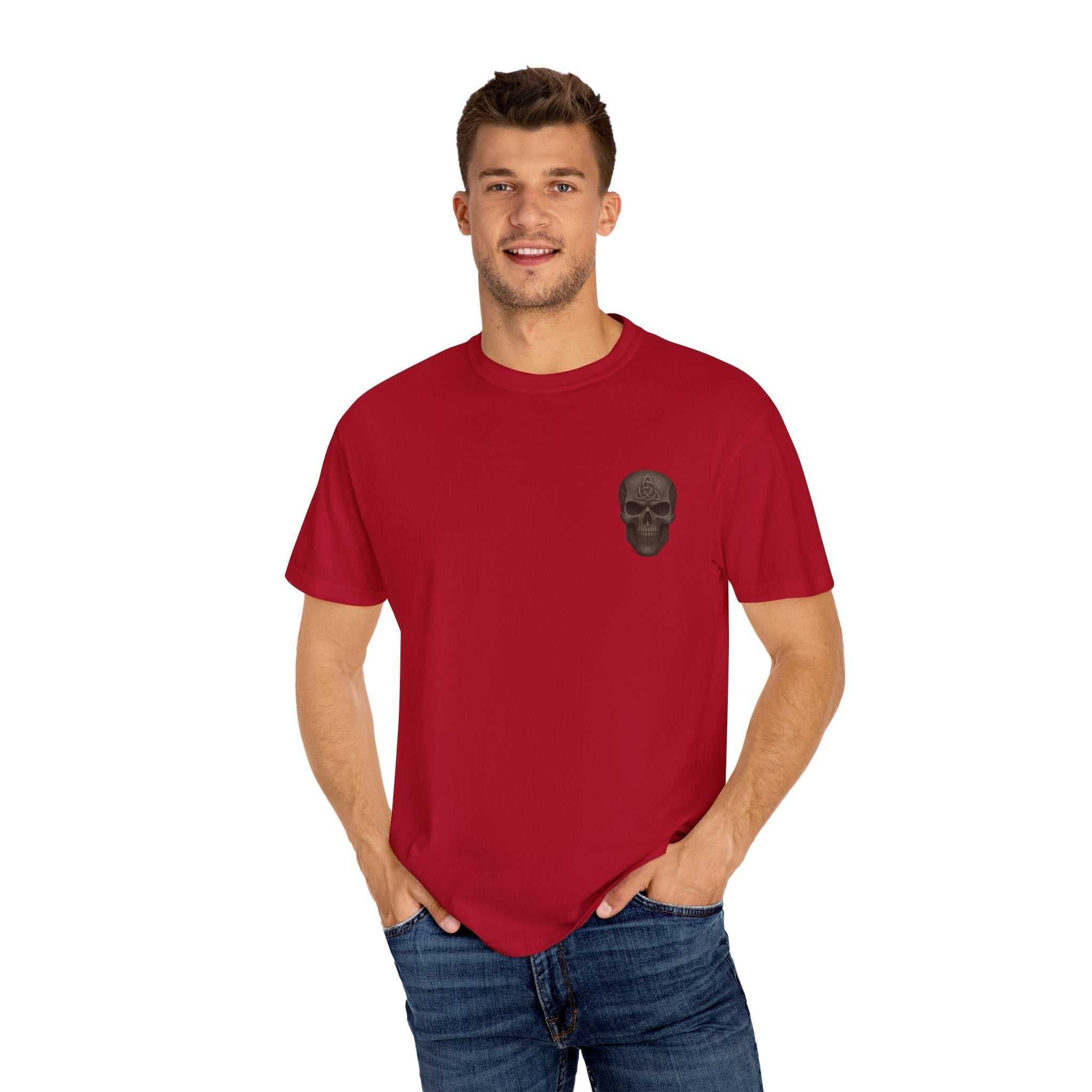 Man wearing red unisex garment-dyed t-shirt with black skull design on chest, casual style