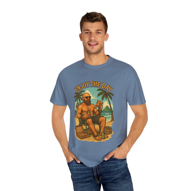 Man wearing blue Atlas Enjoy the Day graphic t-shirt with beach design and relaxed fit.