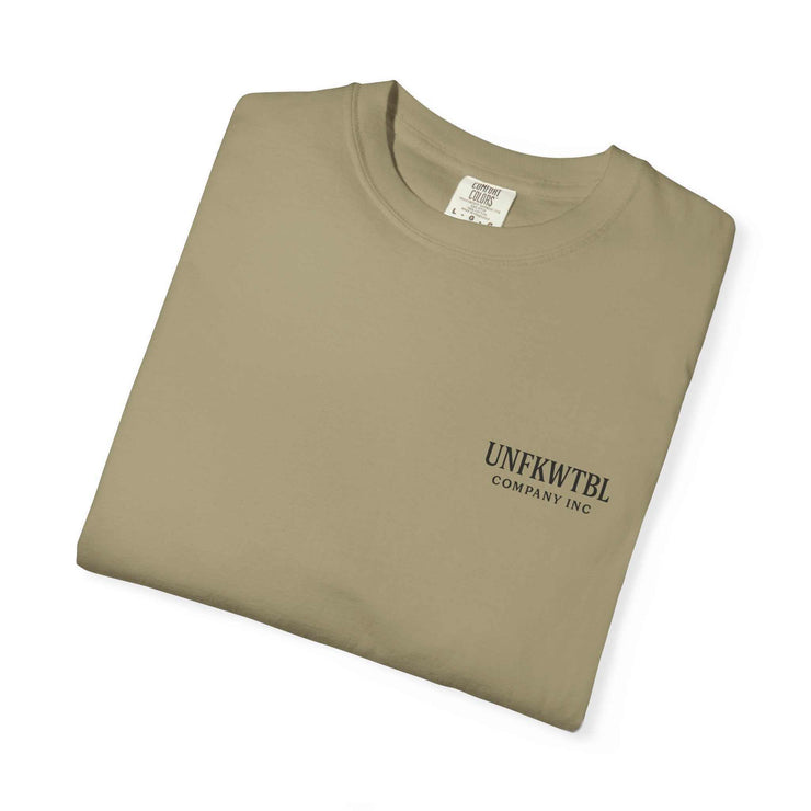 Folded khaki Chucky Cocktail unisex T-shirt with UNFKWTBL Company Inc logo on chest