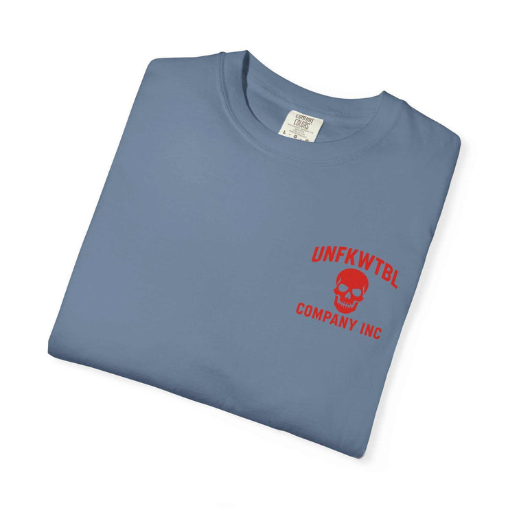 Folded blue graphic tee with red skull logo and text from UNFKWTBL Company Inc.