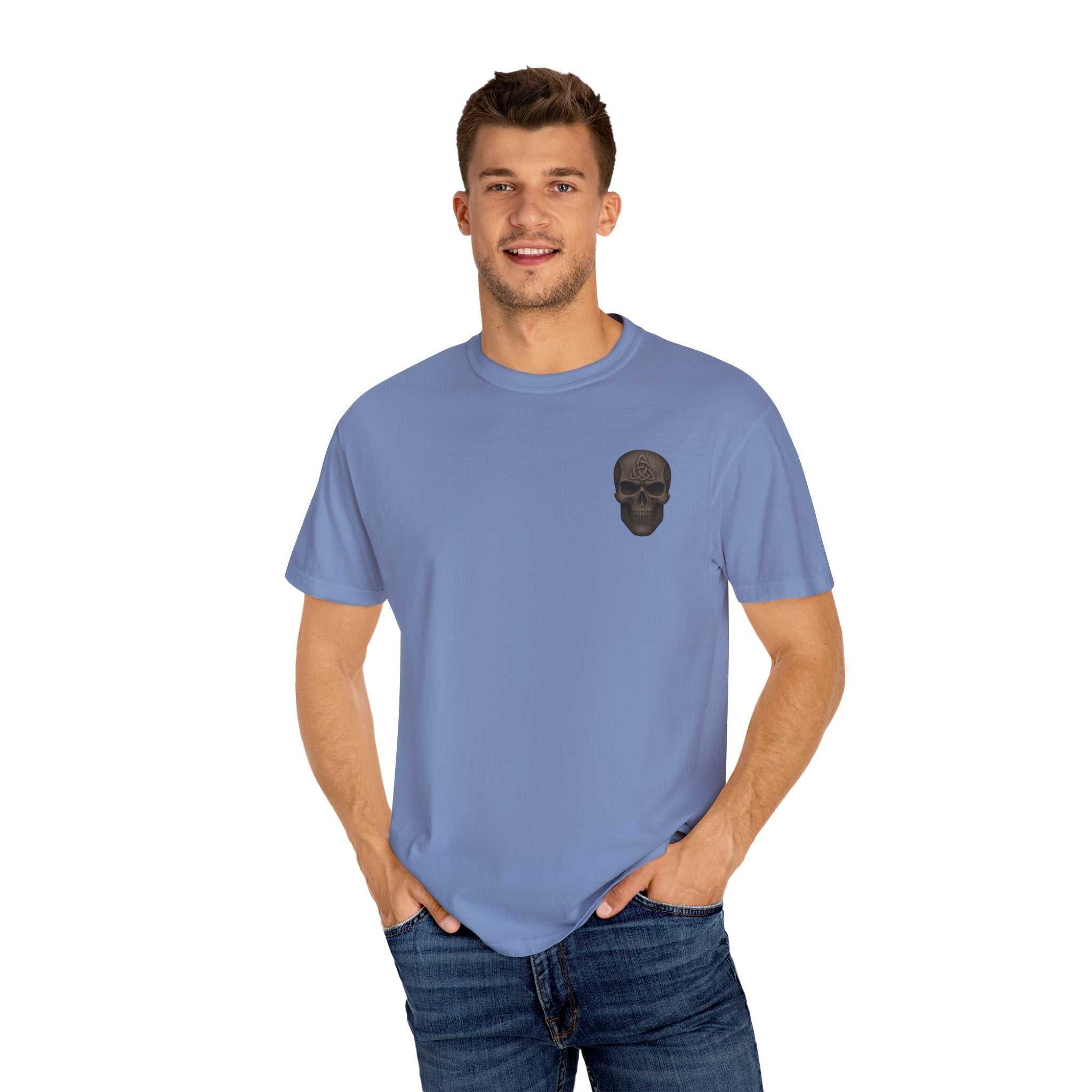 Unisex garment-dyed gladiator t-shirt in blue with a black skull graphic on chest, modeled by a man in casual jeans