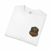 Folded white T-shirt with small palm tree emblem on chest, pirate-themed casual wear