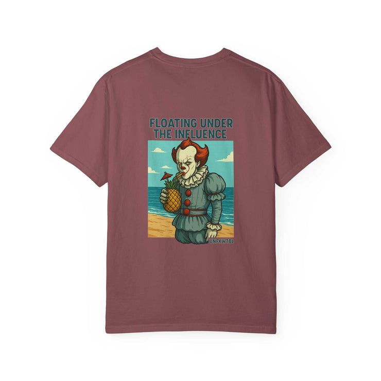 Unisex maroon graphic t-shirt featuring Pennywise holding a pineapple at the beach with text "Floating Under The Influence"
