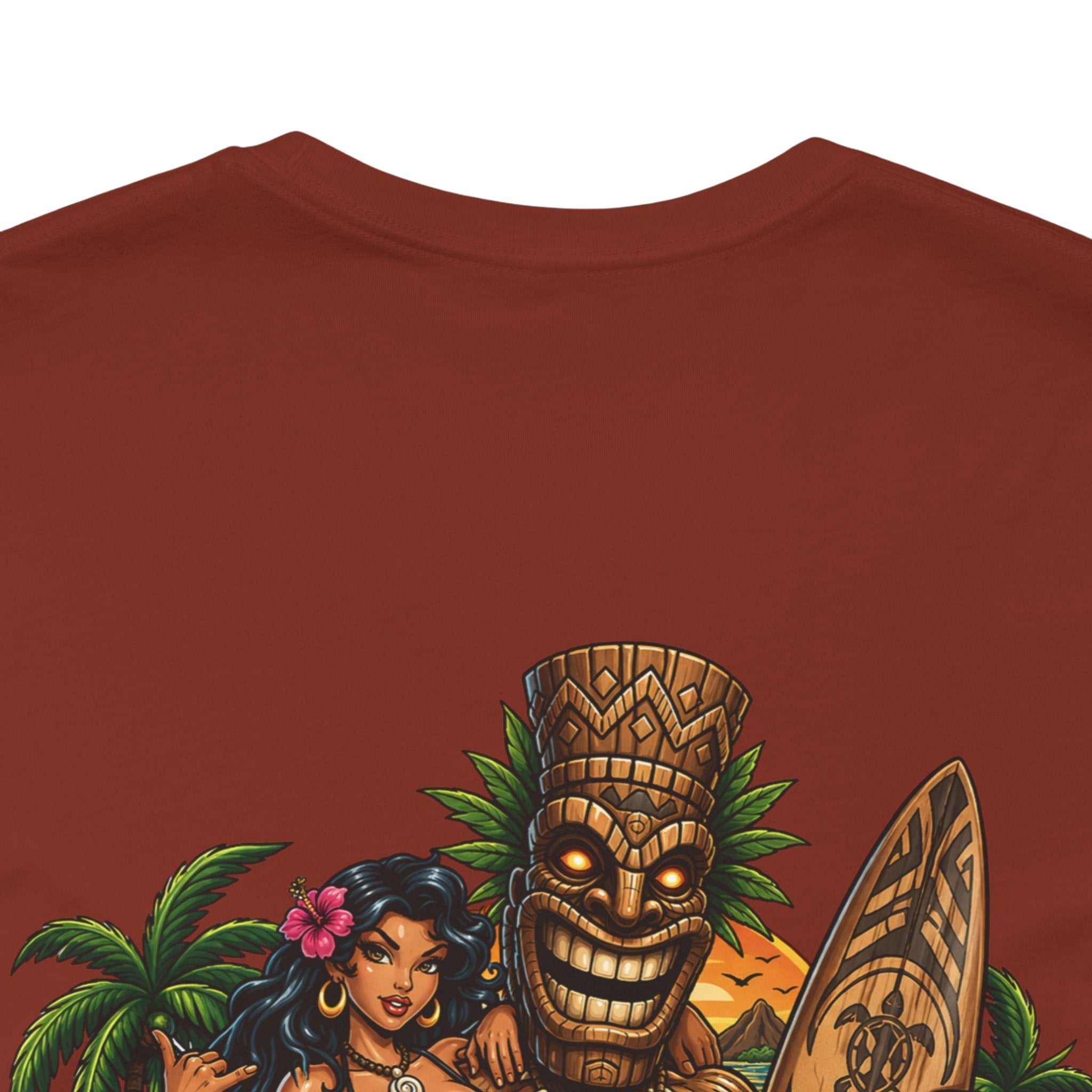 Tropical Tiki Tee with vibrant tiki, hibiscus flowers, and waves design on back, soft breathable cotton shirt for tropical summer style