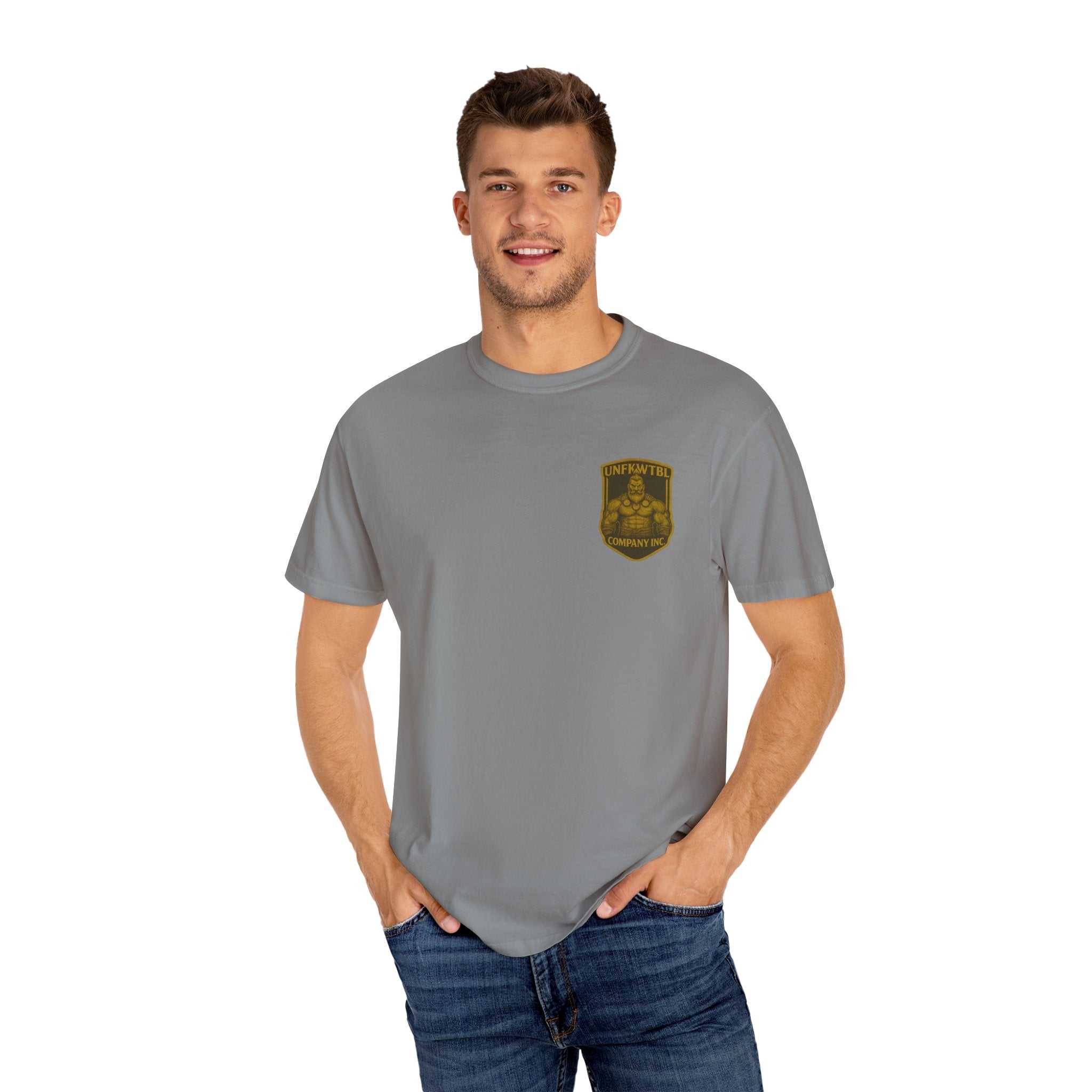 Man wearing Death Dealer unisex garment-dyed grey t-shirt with small chest graphic and jeans
