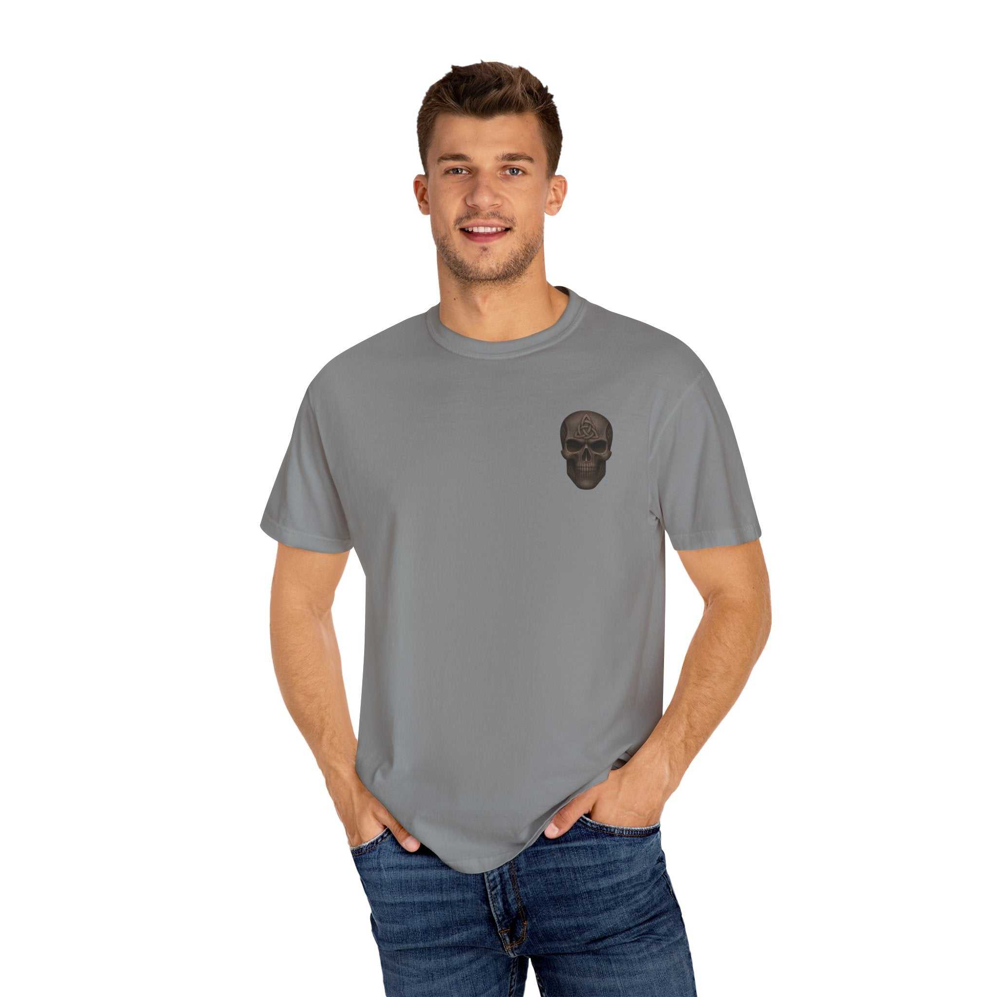 Unisex garment-dyed gray t-shirt with subtle black skull emblem on chest, worn by smiling male model