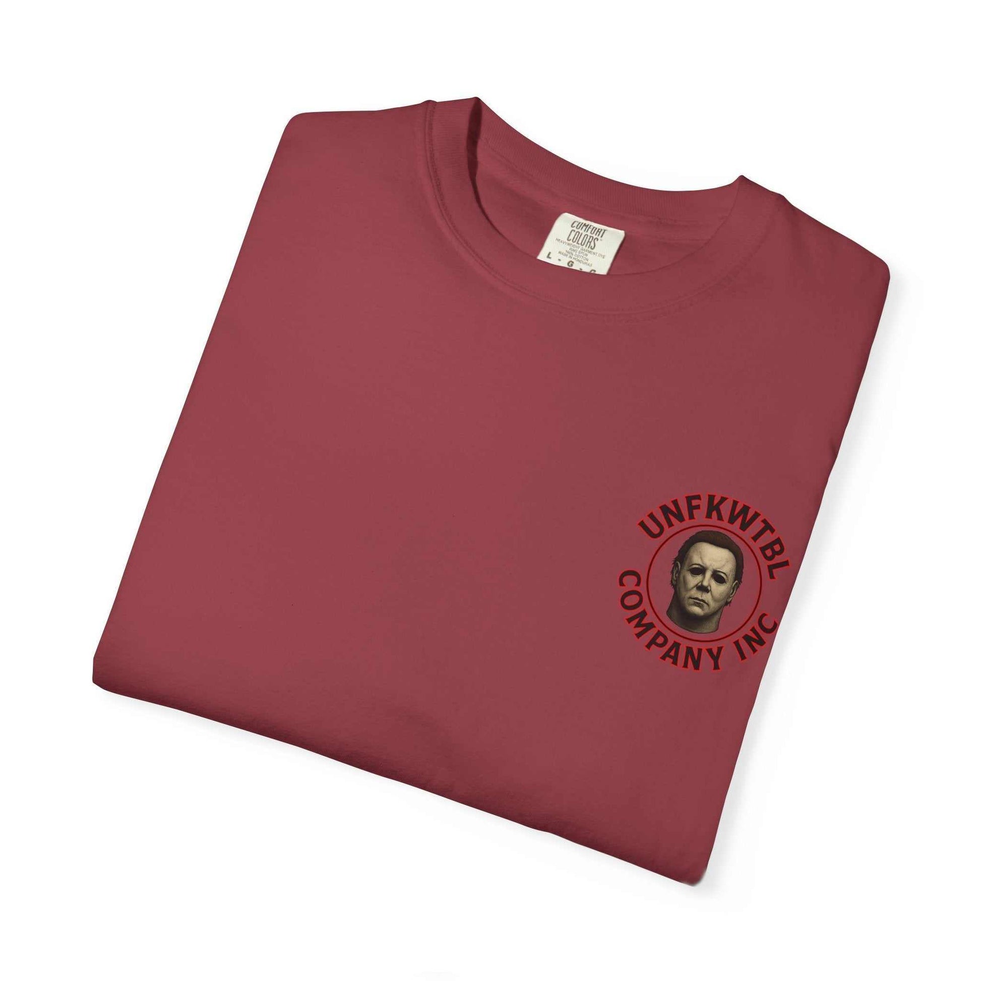 Folded burgundy Jason Voorhees T-shirt with small graphic print on chest showing Jason's mask and company logo